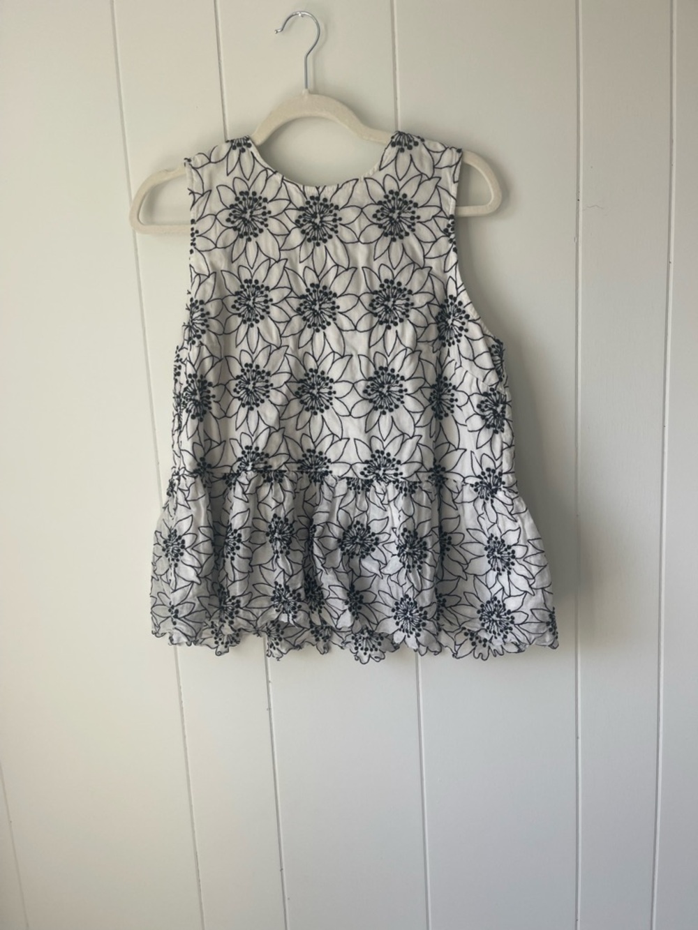 White Sleeveless Peplum Top with Black Floral Embroidery